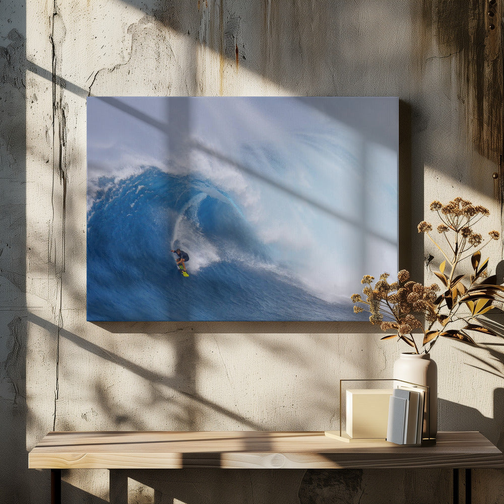 A framed photograph of a professional surfer skillfully riding down the steep face of a massive, cresting blue ocean wave, surrounded by white sea spray. Decor