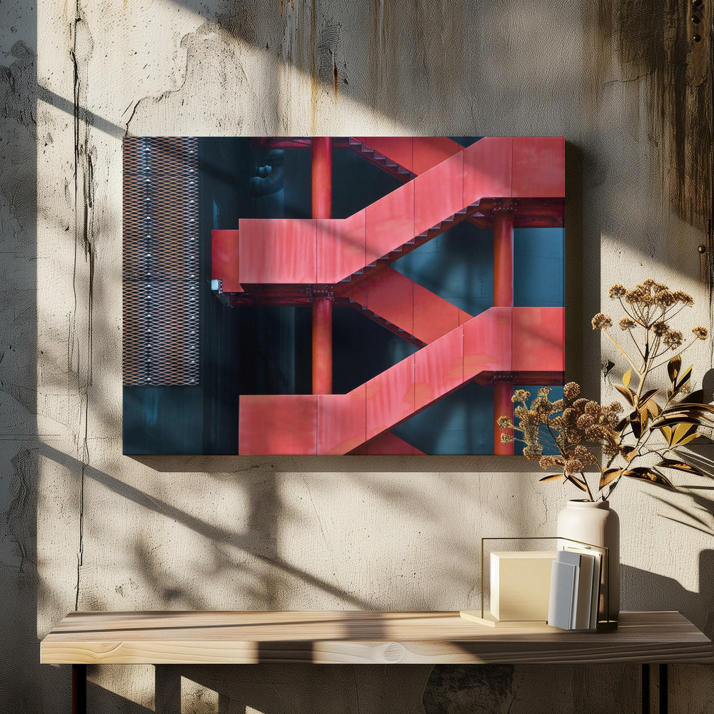 A framed abstract architectural photograph of a bright red industrial staircase zig-zagging against a dark teal wall. The composition highlights the geometric shapes and bold color contrast between the red stairs and the cool-toned background, with a silver mesh panel visible on the left side. Print