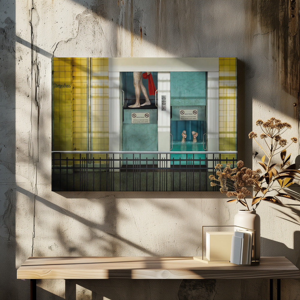 A surreal, framed artwork depicting two teal-colored vertical cabins against a yellow tiled wall. In the left cabin, a person's bare legs are visible as they hold a red towel. In the right cabin, which is filled with water, only a pair of feet can be seen submerged. A black railing is in the foreground, adding to the strange, layered composition. Artwork