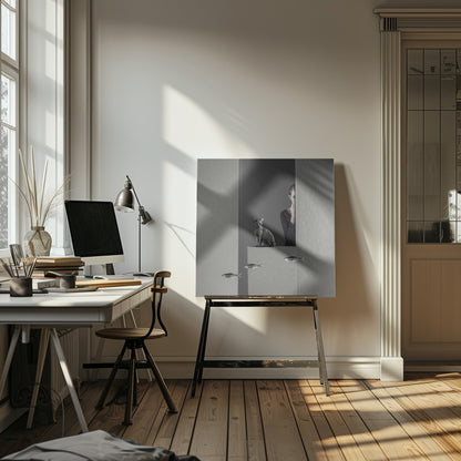 A framed, surreal monochrome photograph featuring a grey cat sitting on a ledge, with a woman partially hidden behind a wall peeking out. Three small fish appear to be floating in a line in the lower part of the image. Poster
