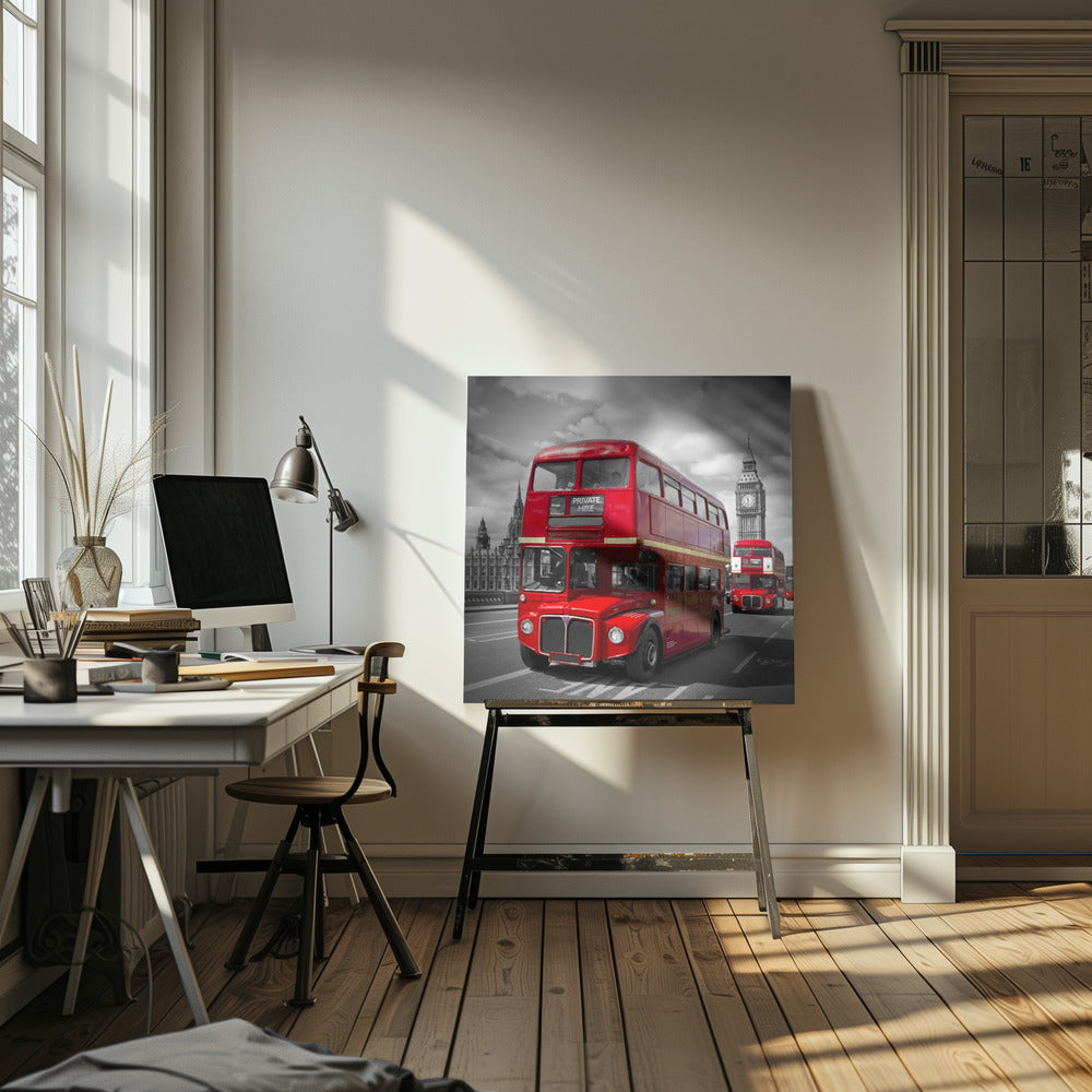 A framed, selective color photograph of a bright red, vintage double-decker bus on a bridge in London. The background, including the Big Ben clock tower, is in black and white, making the red bus stand out. Artwork