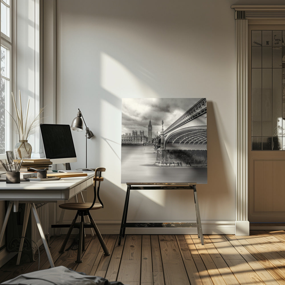 A framed, long-exposure, black and white photograph of London. The image shows Westminster Bridge from a low angle on the right, with the River Thames appearing smooth and misty. In the background on the left are the Houses of Parliament and the Big Ben clock tower under a cloudy sky. Wall Art