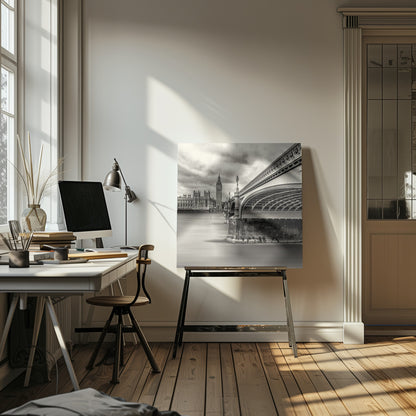 A framed, long-exposure, black and white photograph of London. The image shows Westminster Bridge from a low angle on the right, with the River Thames appearing smooth and misty. In the background on the left are the Houses of Parliament and the Big Ben clock tower under a cloudy sky. Wall Art