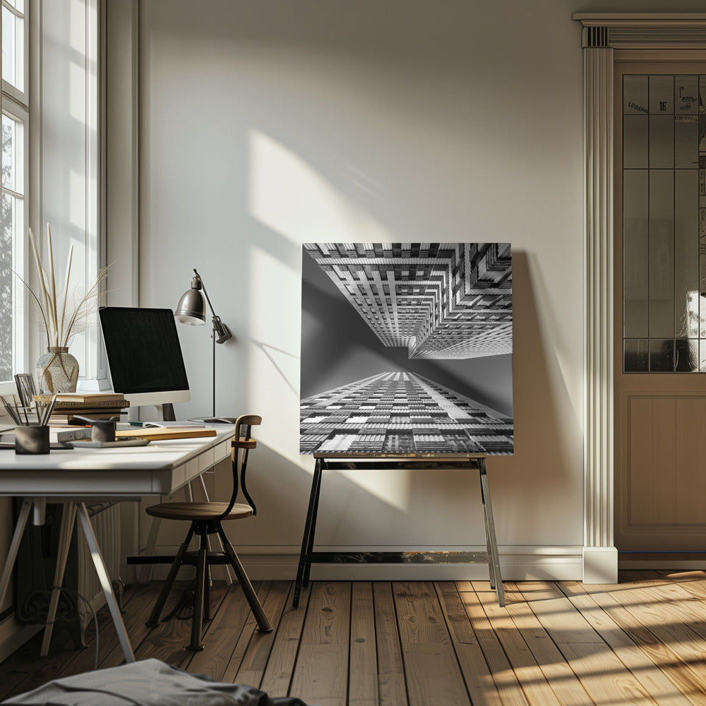A framed, black and white, low-angle photograph looking up between two towering skyscrapers, creating a dramatic perspective with geometric patterns against a dark sky. Poster