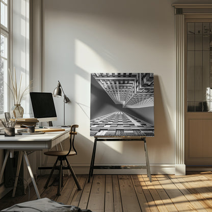 A framed, black and white, low-angle photograph looking up between two towering skyscrapers, creating a dramatic perspective with geometric patterns against a dark sky. Poster