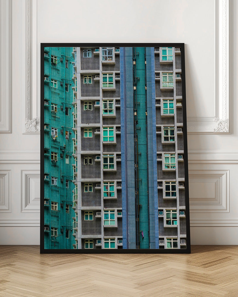 A striking close-up of two densely packed apartment buildings, one with a teal tiled facade and the other with a grey and blue tiled facade, creating a strong pattern of repeating windows and geometric lines. Decor