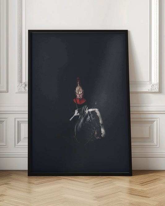 A dramatic portrait of a British Royal Guard on a black horse, emerging from a completely black background. The guard is wearing a traditional uniform with a red collar and a shiny gold helmet with a red plume. Poster