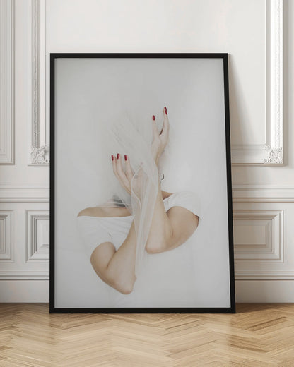 A minimalist photograph of a person in a white t-shirt against a white background, their face hidden by a sheer white veil. Their hands, adorned with bright red nail polish, frame the veiled face in an expressive pose. Wall Art