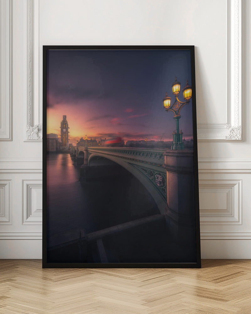 A breathtaking twilight view of Westminster Bridge in London, with the iconic Big Ben illuminated in the background against a purple and orange sunset sky. A vintage street lamp glows warmly in the foreground, and the motion blur of a red bus crosses the bridge over the calm River Thames. Print