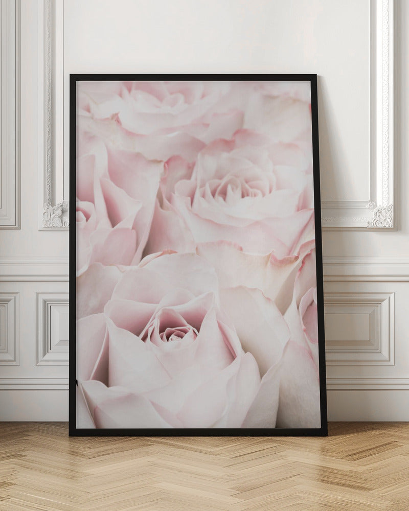 A close-up, soft-focus photograph of a bouquet of delicate, light pink roses filling the entire frame, enclosed in a simple black border. Poster
