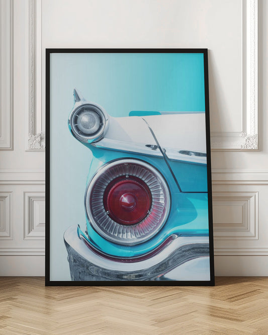 A close-up, framed photograph of the tail fin of a vintage turquoise and white car. The focus is on the large, round, red taillight and the smaller chrome-encased light on the fin, set against a solid light blue background. Poster