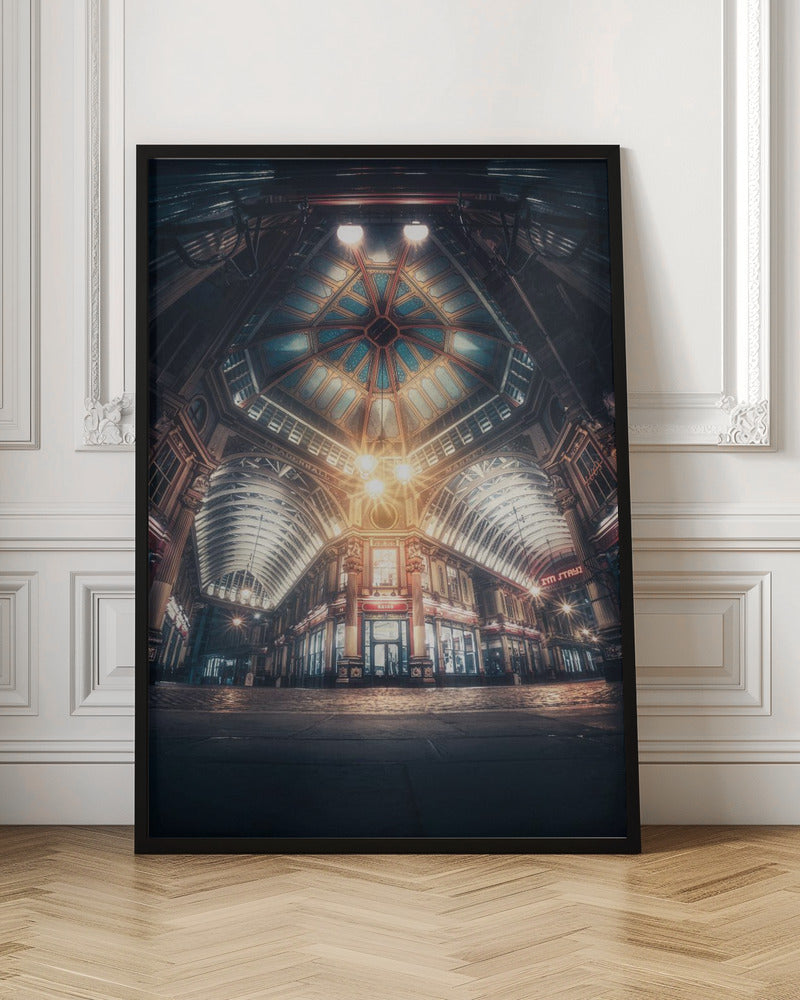 A dramatic, low-angle, wide shot of an empty Leadenhall Market at night. The ornate, domed ceiling is illuminated in blue and gold by bright, warm lights, which also cast a glow on the cobblestone floor and detailed Victorian storefronts. Wall Art