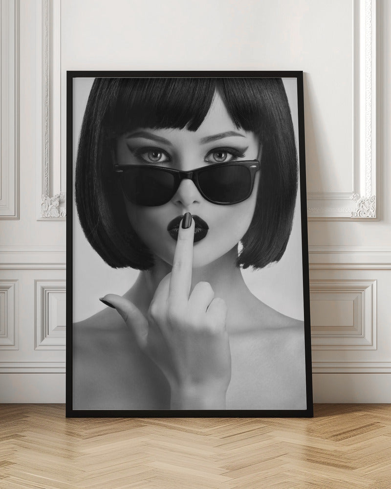 A striking black and white portrait of a woman with a sharp bob haircut, sunglasses, and bold makeup. She holds one finger with a black-painted nail up to her dark lips, making a 'shushing' gesture. Poster