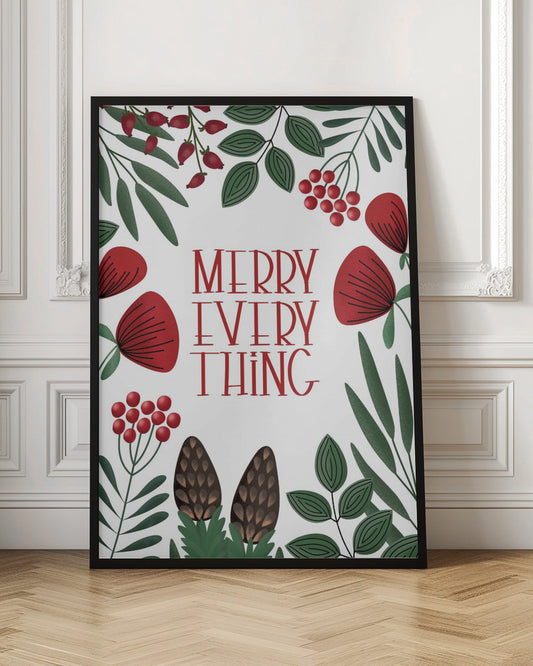 A framed holiday art print with a white background. In the center, the words 'MERRY EVERYTHING' are written in a stylized red serif font. The text is surrounded by a border of illustrated winter botanicals, including red flowers, green leaves, red berries, and brown pinecones. Print