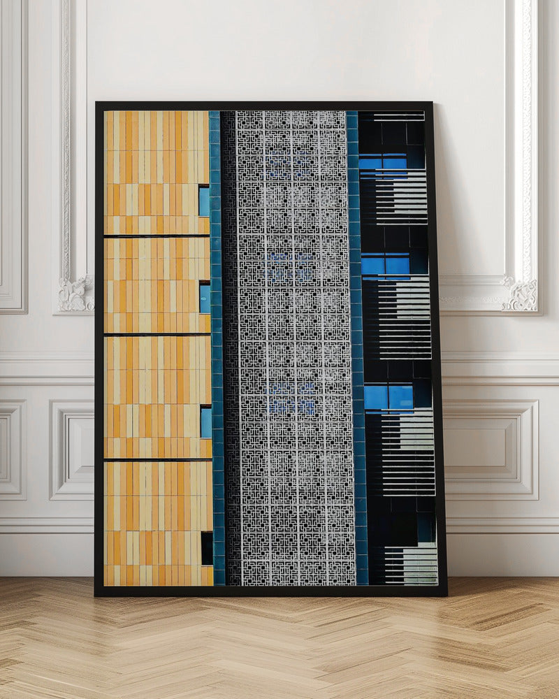 A vertical abstract architectural photograph showcasing the facade of a modern building, featuring a contrast of textures and colors: warm yellow vertical tiles on the left, an intricate white geometric screen in the center, and a dark section with vibrant blue windows on the right. Print