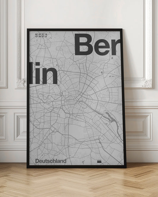 A minimalist, framed poster of a street map of Berlin, Germany. The map is rendered in shades of gray, with large, bold black text spelling 'Berlin' overlaid on the map. The city's coordinates and the word 'Deutschland' are also included in a clean, modern font. Wall Art