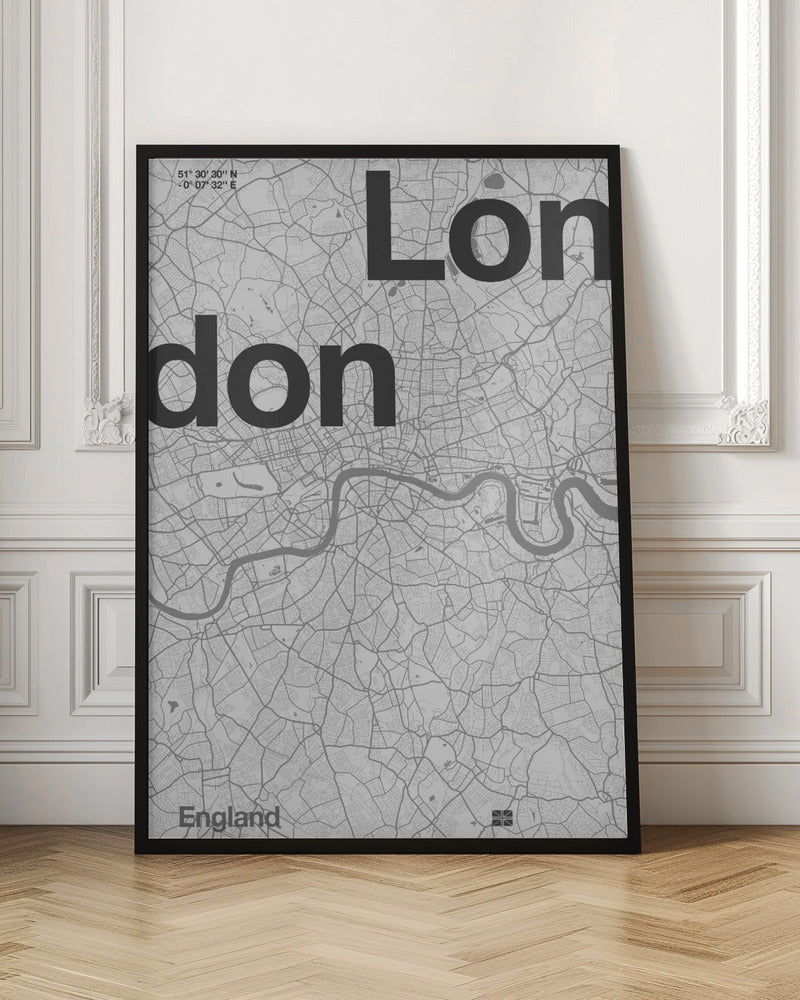 A framed, minimalist black and white street map of London. The word 'London' is split into two lines, 'Lon' and 'don', in large, bold black font overlaid on the light grey map. The River Thames snakes through the center in a darker grey, matching the intricate street grid. Coordinates are in the top left corner, and 'England' is in the bottom left. Decor