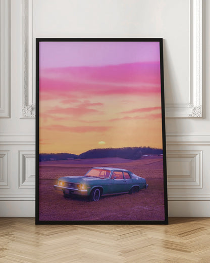 A vintage green muscle car is parked in a purple-hued field under a vibrant sunset sky that blends from orange to a vivid pink. The car's headlights are glowing, and the sun is setting behind distant hills, creating a dreamy, retro atmosphere. Decor