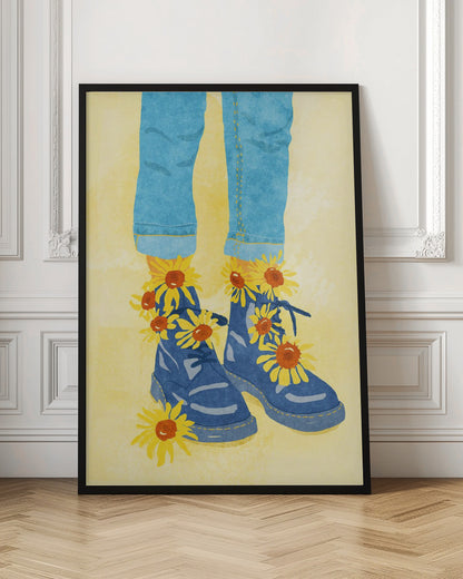 An illustration of a person's lower legs and feet wearing cuffed blue jeans and blue combat boots against a pale yellow background. Bright yellow and orange sunflowers are blooming out of the boots and laces. Poster