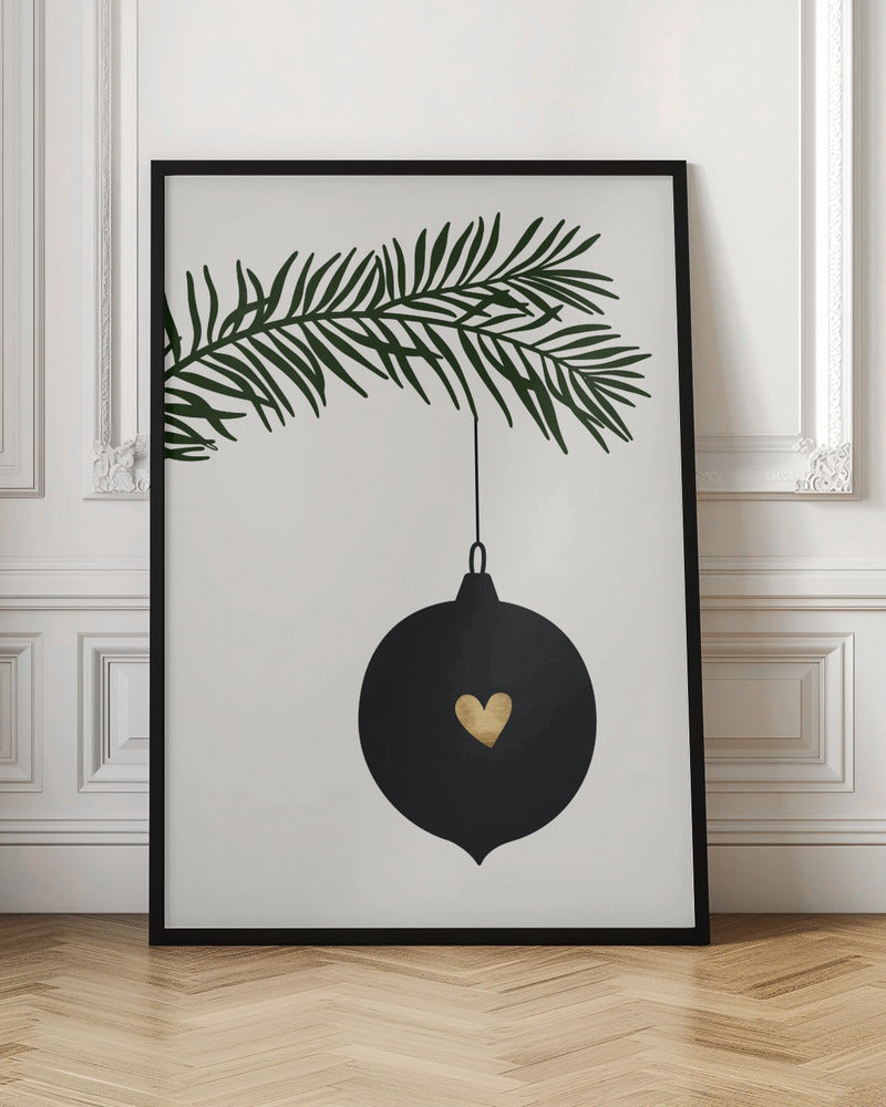 A minimalist digital illustration of a black Christmas ornament with a small gold heart in the center, hanging from a dark green pine branch against a cream-colored background, all enclosed in a thin black frame. Artwork