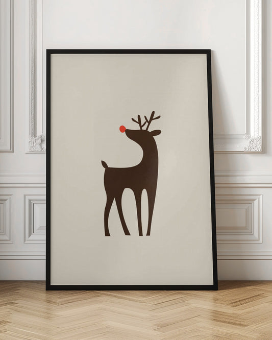 A minimalist art print of a stylized brown reindeer with a bright red nose, standing in profile against a cream-colored background, all enclosed in a simple black frame. Print