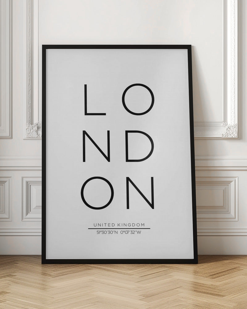 A minimalist black and white typographic poster featuring the word 'LONDON' arranged vertically in a modern sans-serif font. Below the city name, it displays 'UNITED KINGDOM' and its geographic coordinates, all enclosed within a thin black frame. Poster