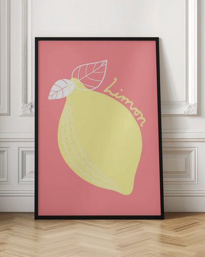 A stylized illustration of a large yellow lemon on a solid pink background. The lemon has two white-outlined leaves, and the word 'Limon' is written in cursive script across the fruit. The artwork is enclosed in a thin black frame. Print