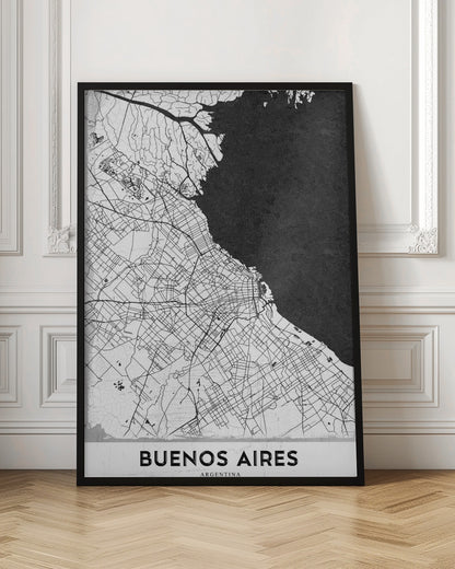 A minimalist black and white map of Buenos Aires, presented as a poster in a black frame. The city's roads and geography are detailed in black lines on a white background, while the adjacent body of water is solid black. The text 'BUENOS AIRES' is displayed at the bottom. Wall Art