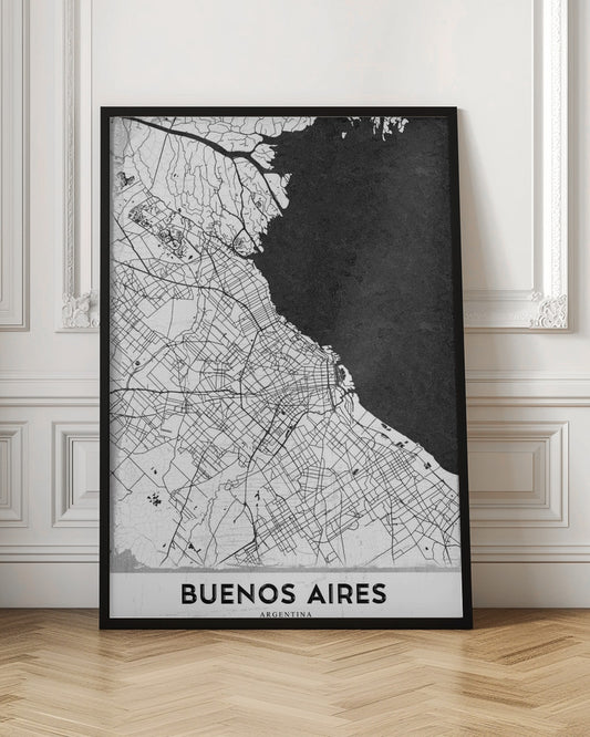A minimalist black and white map of Buenos Aires, presented as a poster in a black frame. The city's roads and geography are detailed in black lines on a white background, while the adjacent body of water is solid black. The text 'BUENOS AIRES' is displayed at the bottom. Wall Art