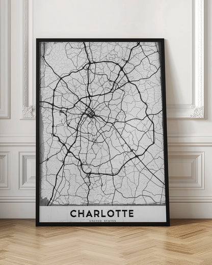 A minimalist black and white street map of Charlotte, North Carolina. The map highlights the major roads and highways as thick black lines on a distressed, crackled white background. The artwork is framed in black with the word 'CHARLOTTE' printed in bold capital letters at the bottom. Poster