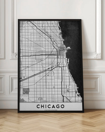 A minimalist black and white map of Chicago, featuring a grid street layout, major thoroughfares, and the shoreline of Lake Michigan. The map has a subtle crackled texture, is enclosed in a black frame, and has the word 'CHICAGO' in capital letters at the bottom. Decor