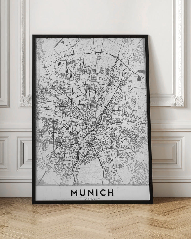 A minimalist black and white street map of Munich, Germany, presented in a thin black frame. The map shows intricate road networks and geographical features on a textured white background, with the word 'MUNICH' in a bold, black, sans-serif font at the bottom. Wall Art