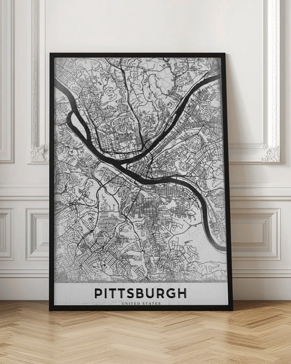 A minimalist black and white map of Pittsburgh, Pennsylvania, in a black frame. The map details the city's streets and the confluence of the Allegheny, Monongahela, and Ohio rivers. The word 'PITTSBURGH' is printed in a bold, sans-serif font at the bottom. Decor