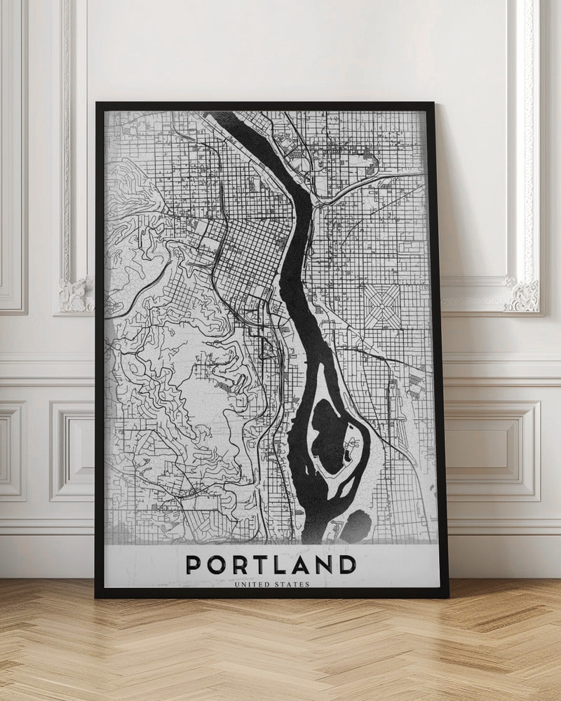 A framed, black and white street map of Portland, Oregon. The map is stylized with black lines for streets on a textured white background, and the Willamette River is depicted in solid black. The word 'PORTLAND' is written in a bold, black, sans-serif font at the bottom. Decor