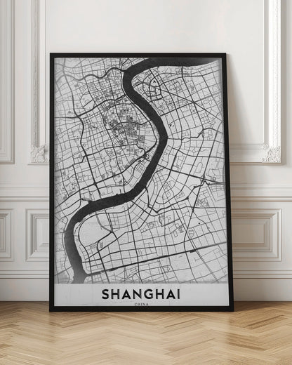 A minimalist black and white street map of Shanghai in a black frame. The map highlights the city's road network and the prominent Huangpu River, with the name 'SHANGHAI' printed at the bottom. Decor