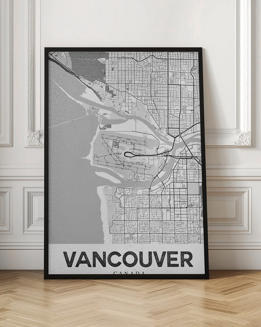 A modern, black and white framed art print of a city map of Vancouver. The map features a stylized layout of roads, rivers, and the coastline, including what appears to be an airport. The word 'VANCOUVER' is displayed in bold, capital letters at the bottom. Poster