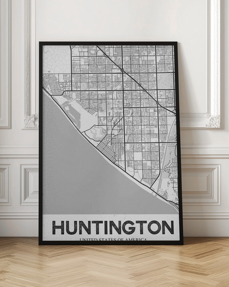 A minimalist black and white framed map of Huntington. The map details the city's street grid next to the coastline, with the name 'HUNTINGTON' printed in bold block letters at the bottom. Print