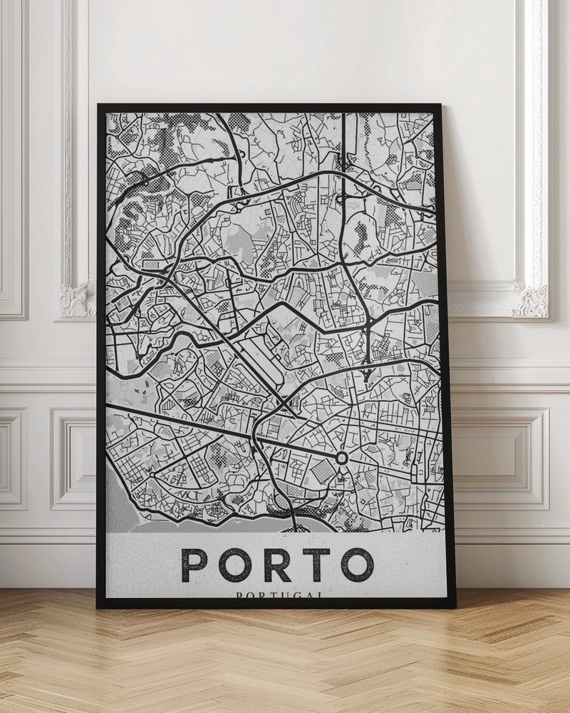 A minimalist black and white art print of a city map of Porto, Portugal, enclosed in a black frame. The map features a stylized network of roads and city blocks, with some areas shaded in grey or with a dot pattern. The word 'PORTO' is printed in large, bold, black capital letters at the bottom on a white background. Print