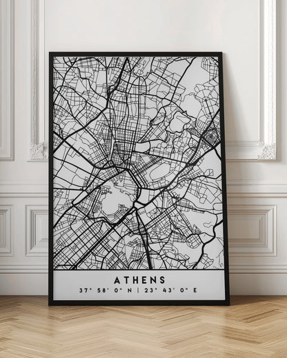 A minimalist black and white poster of a street map of Athens, Greece, enclosed in a simple black frame. The map consists of intricate black lines on a white background, showing the city's road network. At the bottom, centered, is the text 'ATHENS' in a bold, uppercase font, with its geographical coordinates '37° 58' 0" N | 23° 43' 0" E' listed below. Poster
