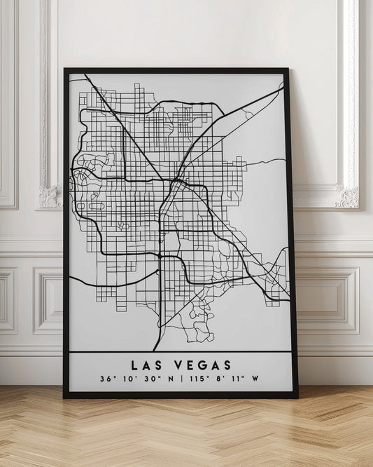 A minimalist black and white framed map of Las Vegas, showcasing the city's street grid and major highways. Below the map, the city's name and geographical coordinates are printed in a clean, modern font. Poster