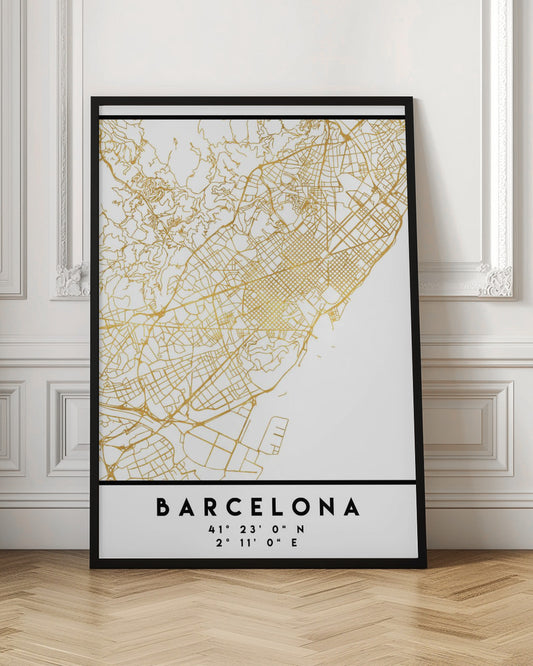 A modern, minimalist framed poster featuring a gold line map of Barcelona, Spain, on a clean white background. Below the map, the city's name 'BARCELONA' is printed in bold black text, with its geographic coordinates listed underneath. Decor