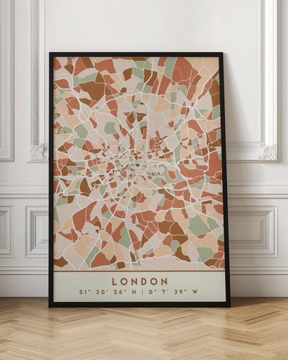 An abstract, framed map of London created with a mosaic of colored shapes in an earth-toned palette of brown, terracotta, sage green, and beige. White lines representing streets separate the shapes, converging towards the city center. Below the map, the word 'LONDON' and its geographic coordinates are displayed on a cream-colored border. Wall Art