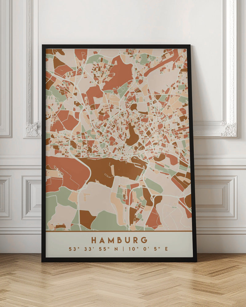 A modern, stylized art print of a Hamburg city map, featuring an abstract pattern of streets and neighborhoods in a color palette of terracotta, brown, sage green, and cream. The bottom of the print has a cream border with the city's name 'HAMBURG' and its geographical coordinates. The artwork is presented in a thin black frame. Wall Art