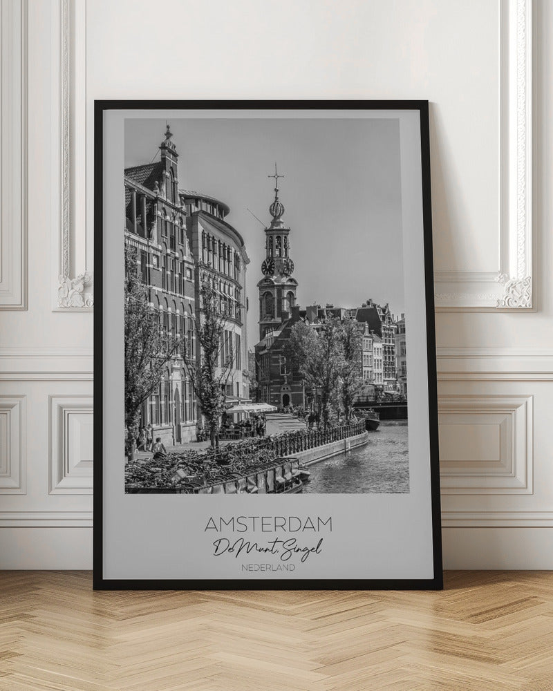 A black and white travel poster of Amsterdam, Netherlands. The photo shows the Munttoren clock tower and traditional Dutch buildings along the Singel canal. A floating barge filled with bicycles is in the foreground. The poster has a white border with the text 'AMSTERDAM', 'De Munt, Singel', and 'NEDERLAND' at the bottom. Artwork