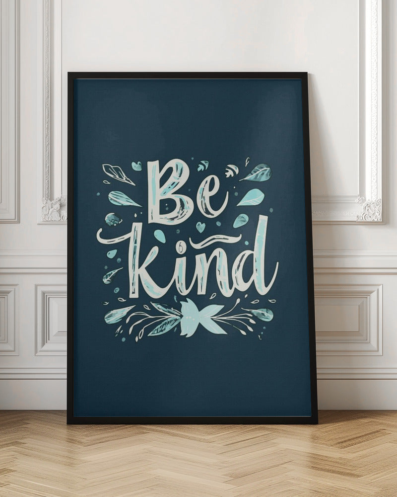 An inspirational art print with a dark blue background featuring the phrase 'Be Kind' in a stylized, hand-lettered white and light blue font. The text is decorated with small leaves, hearts, and flourishes in shades of teal and white. Artwork