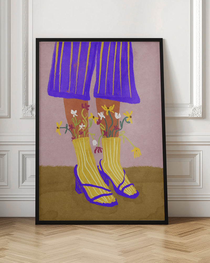 A stylized, colorful illustration focusing on the lower legs and feet of a person wearing vibrant clothing. They have on wide-legged, royal blue trousers with vertical yellow stripes, and yellow socks with white stripes. Small, colorful wildflowers sprout from the tops of their socks. They are wearing bright blue strappy heeled sandals. The background is a soft pink color with a brown floor. Wall Art