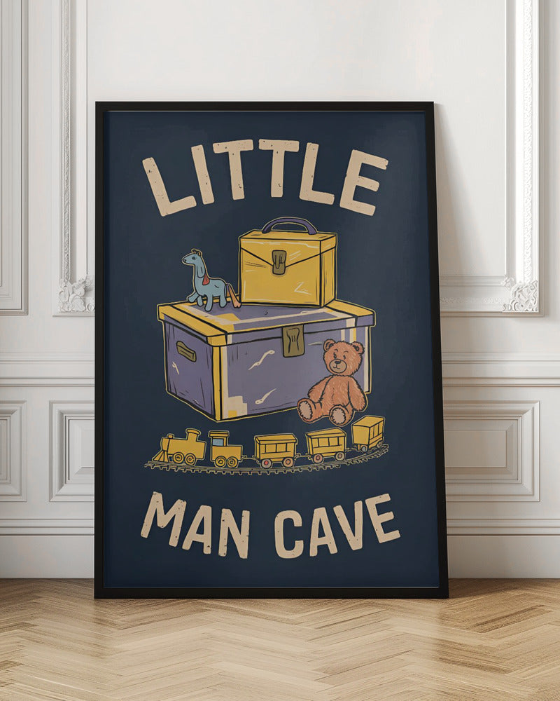 A framed vintage-style illustration with the text 'LITTLE MAN CAVE' on a dark blue background. The artwork features classic toys, including a toy chest, a teddy bear, a toy train on tracks, and a small horse on wheels. Decor