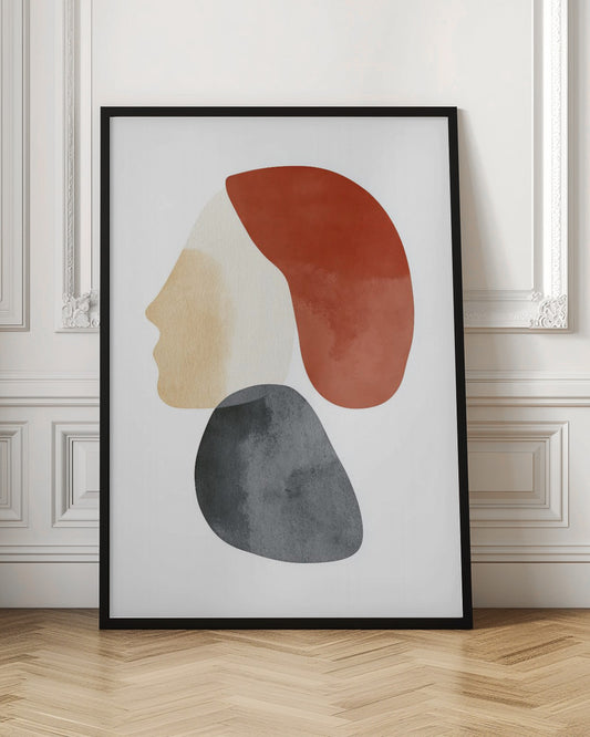 A minimalist abstract artwork in a black frame, featuring overlapping shapes that form a stylized human profile. The face is a light beige, topped with a rust-red shape like hair, and a dark grey, stone-like shape is positioned below the chin, all on a white background. Artwork