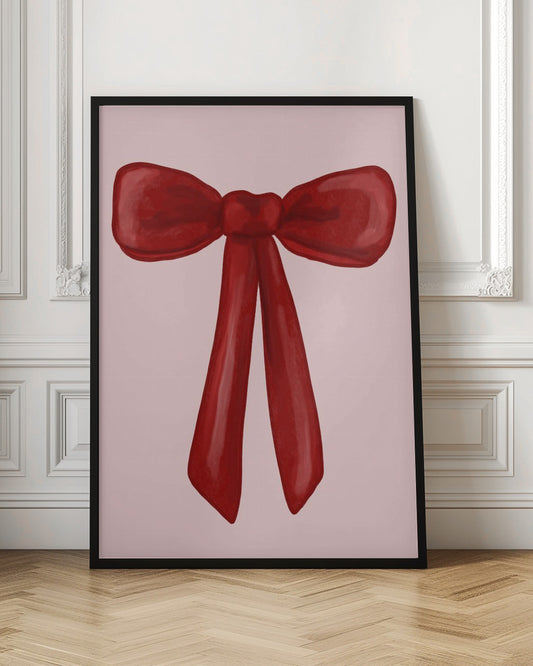 A digital painting of a large, shiny red ribbon tied into a bow, centered against a solid light pink background. The artwork is shown within a thin black frame. Print