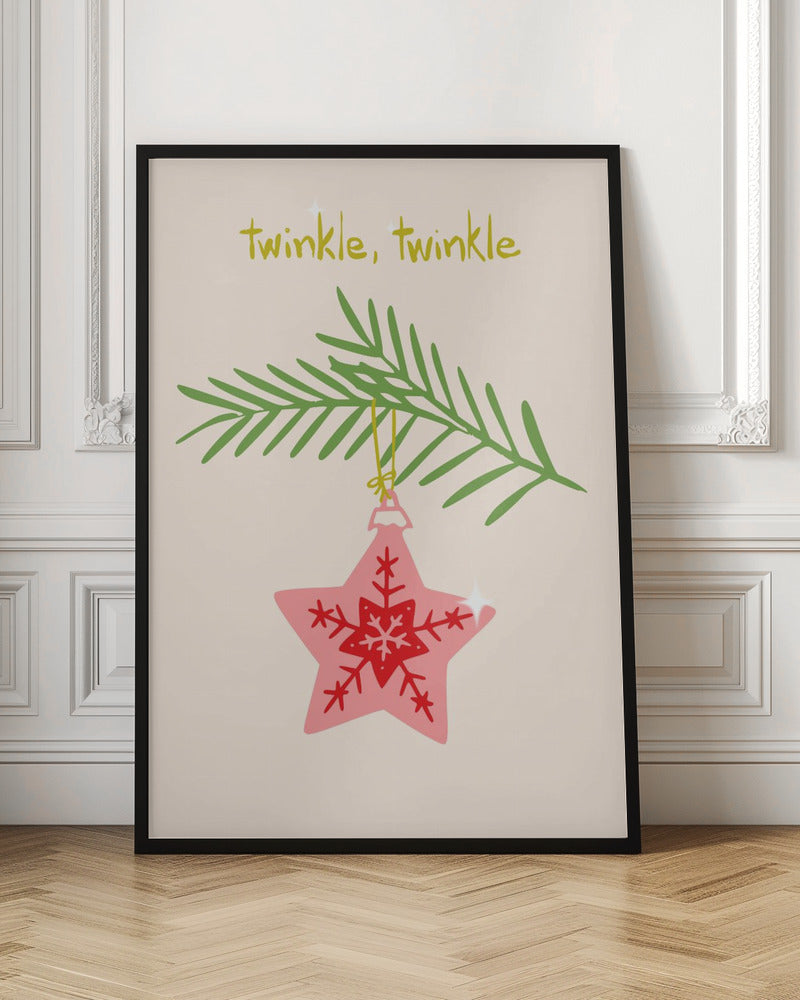 A framed piece of art with a light cream background featuring the words 'twinkle, twinkle' in a playful yellow-green font. Below the text, a pink star-shaped Christmas ornament with red snowflake designs hangs from a green pine branch. Print